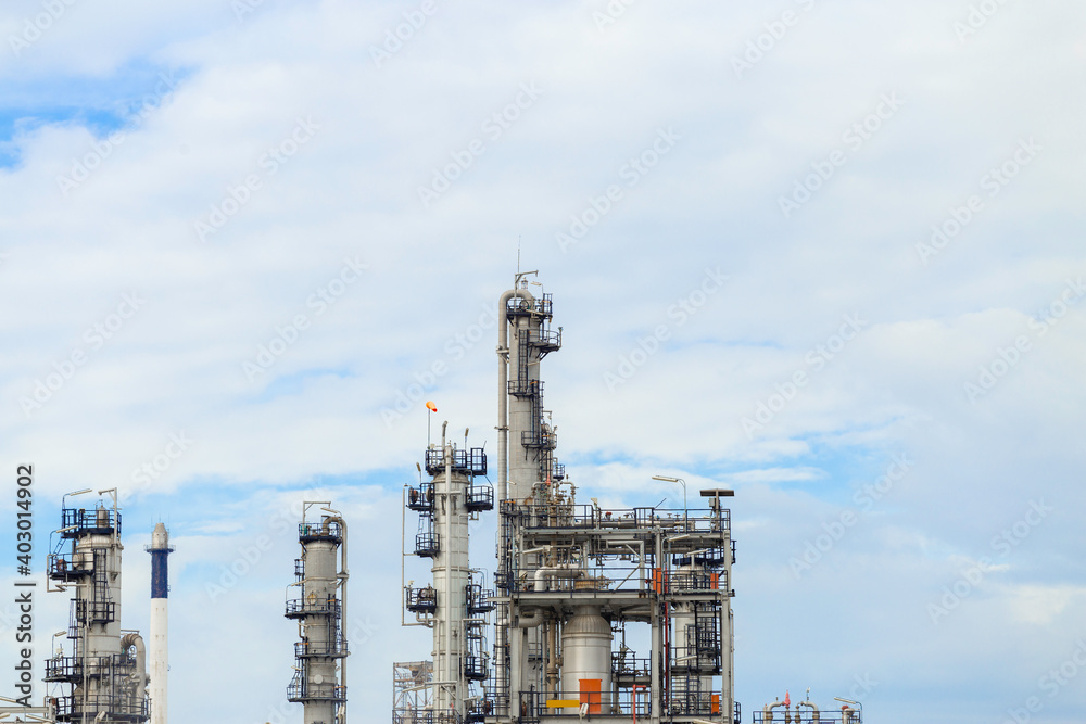 Obraz premium Industrial of oil refinery plant from industry zone ,Refinery factory oil storage tank and pipeline steel with blue sky.