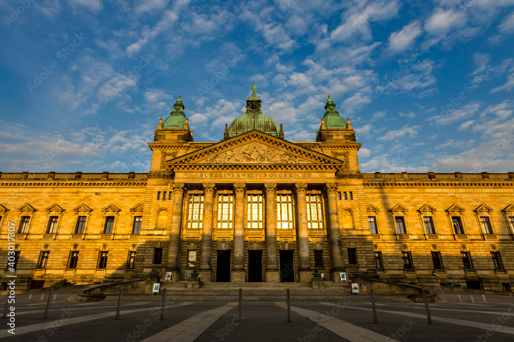 Fototapeta premium Sunrise at the federal high court building at the city of Leipzig. German federal court in downtown of Leipzig. In the time of the GDR, the Bundesverwaltungsgericht was the Georgi Dimitroff Museum.