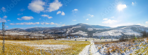 Superb panoramic snow-covered winter landscape in the mountains at sunshine weather. Part of the Ukrainian Carpathians in Transcarpathia, village Latirka. photo