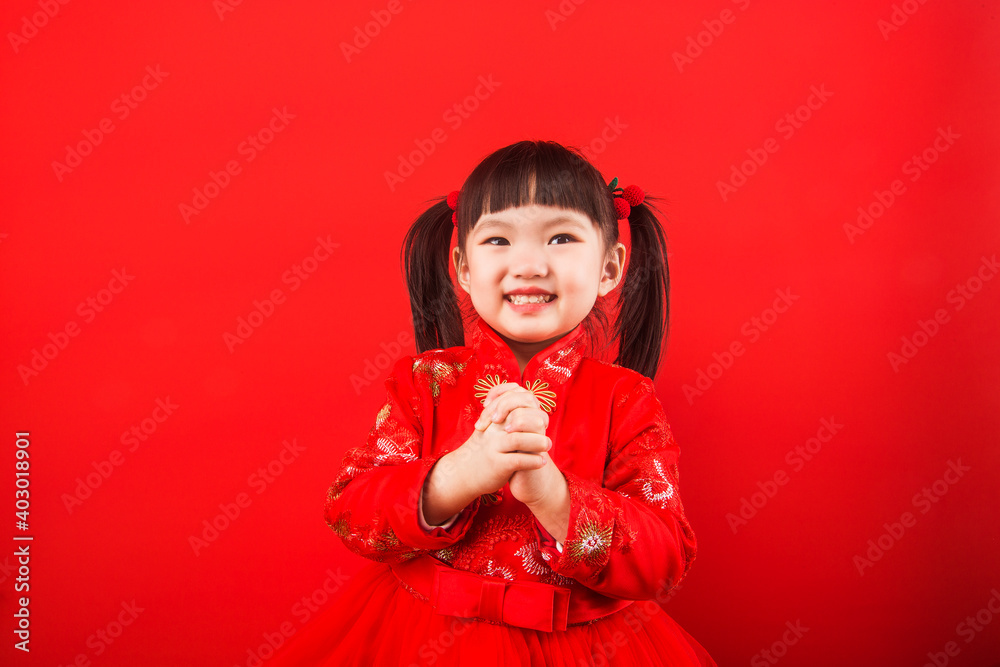 A Chinese girl celebrates Chinese New Year with a red envelope