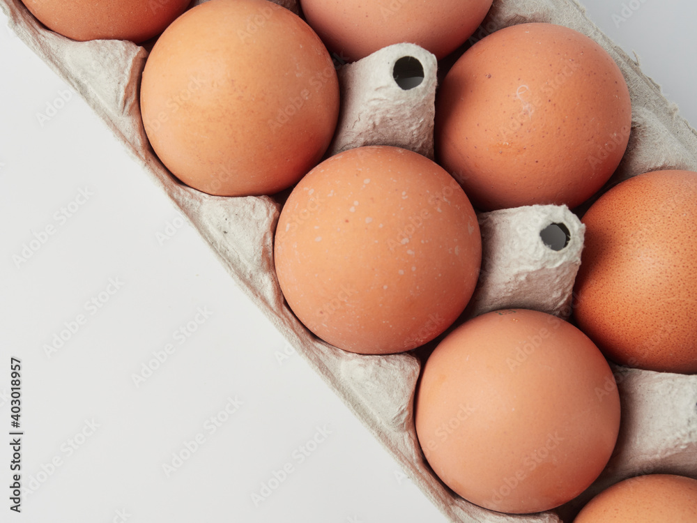 Chicken eggs in containers on a white background. Chicken eggs in containers on a white background.