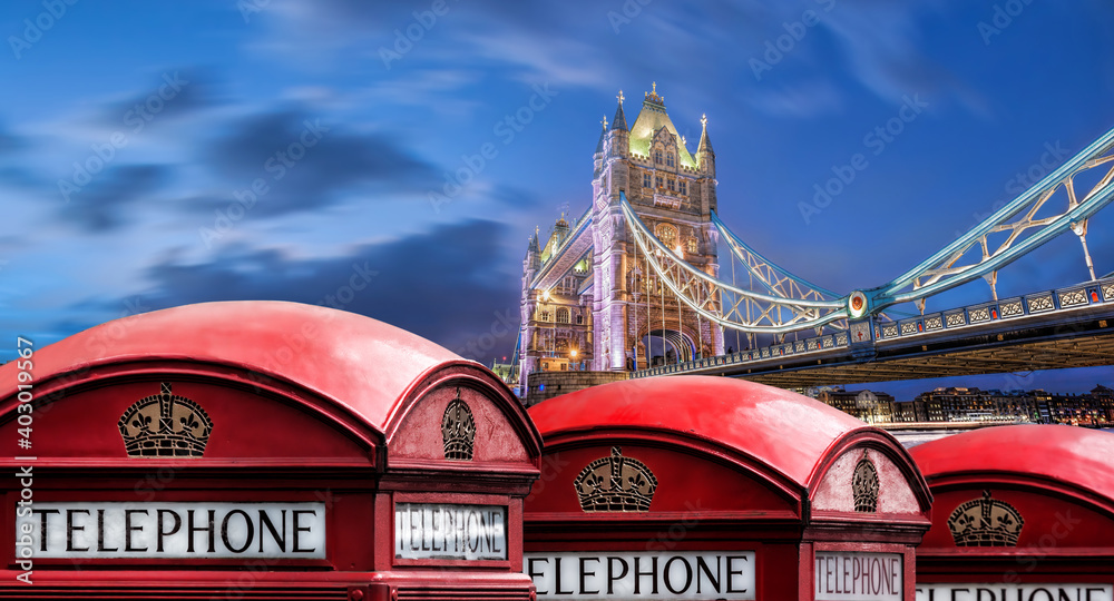 London symbols with Tower bridge against red phone boots in England, UK London symbols with Tower bridge against red phone boots in England, UK