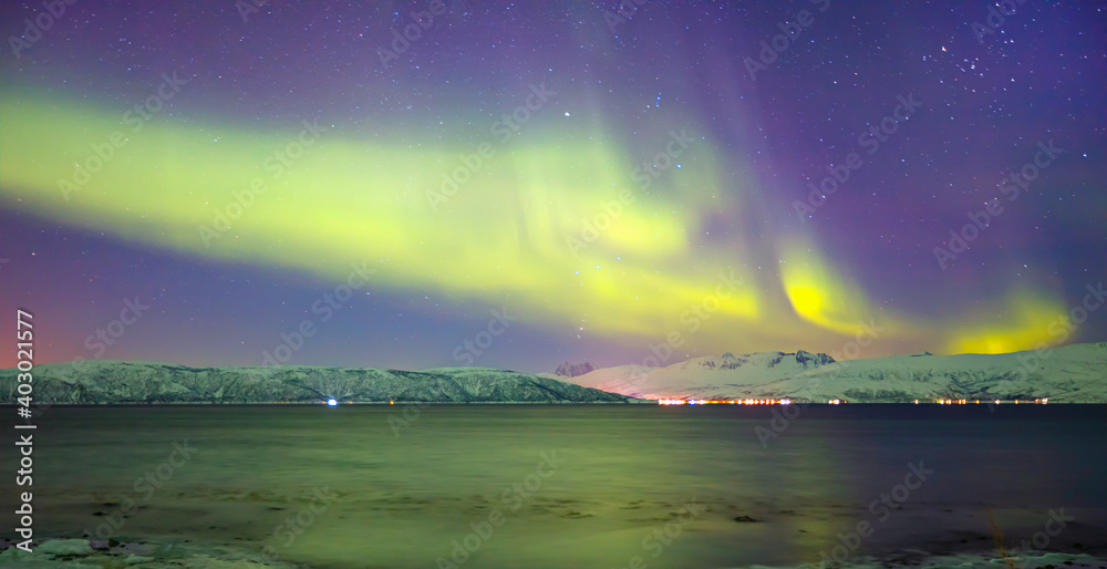 Aurora borealis or Northern lights in the sky over Tromso,  Norway