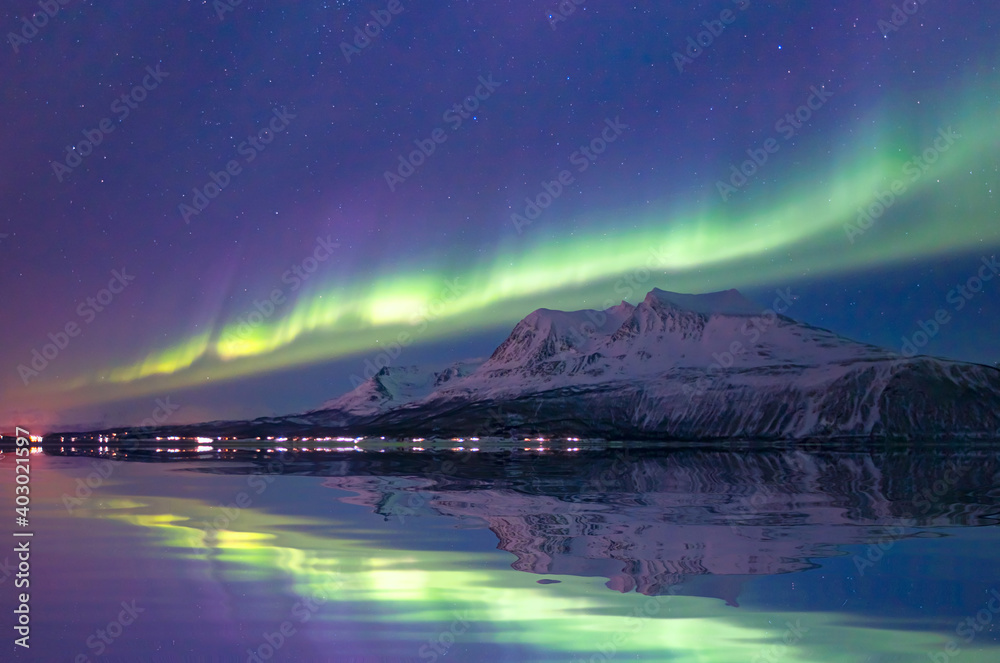 Aurora borealis or Northern lights in the sky over Tromso,  Norway