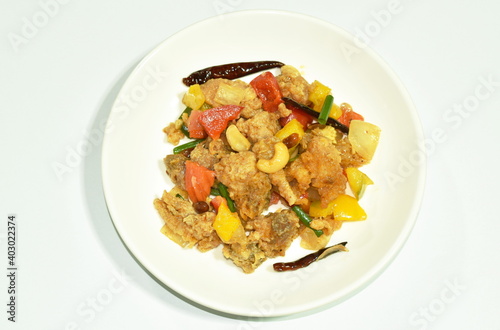 fried chicken with cashew nut and slice onion on plate