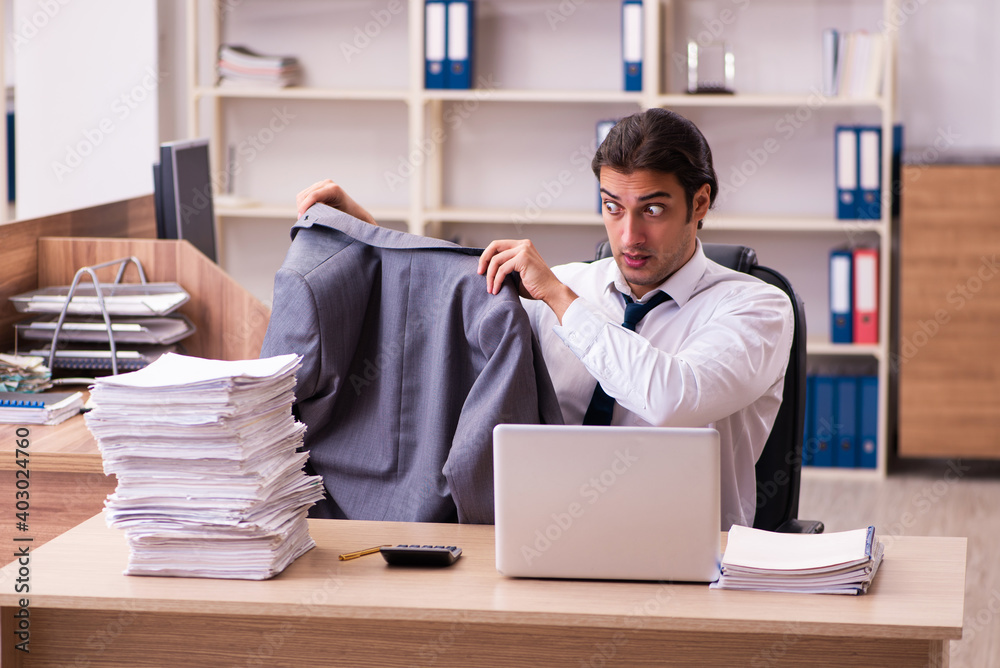 Young male employee unhappy with excessive work in the office