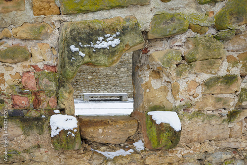 Bench behind old stone wall