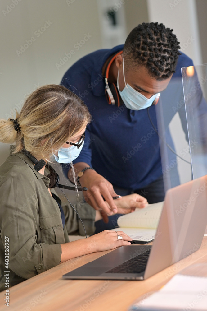 Start-up people working in co-working space office, wearing face mask during 19-ncov pandemic Start-up people working in co-working space office, wearing face mask during 19-ncov pandemic