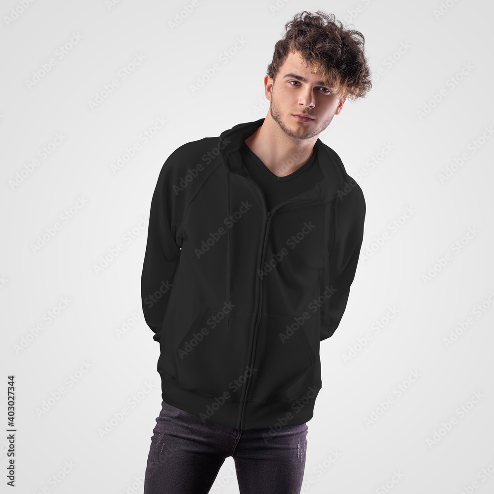 Black hoodie mockup with pocket, zipper closure, drawstrings on the hood, dressed on a guy, front view, isolated on background. Black hoodie mockup with pocket, zipper closure, drawstrings on the hood, dressed on a guy, front view, isolated on background.