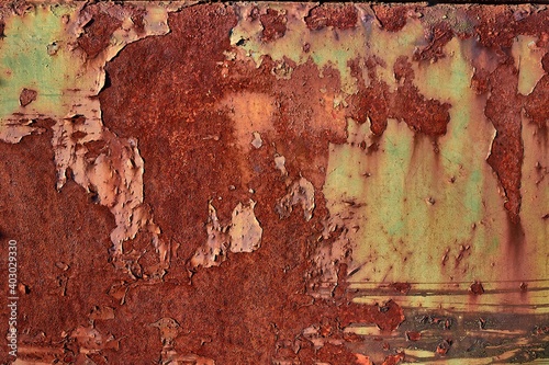 Fotografie Texture of a rusty stained metal gate with paindwork peeling off