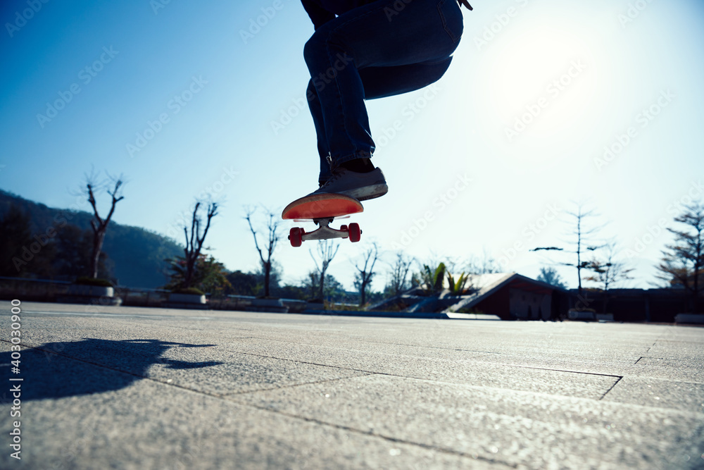 Asian woman skateboarder skateboarding outdoors Asian woman skateboarder skateboarding outdoors