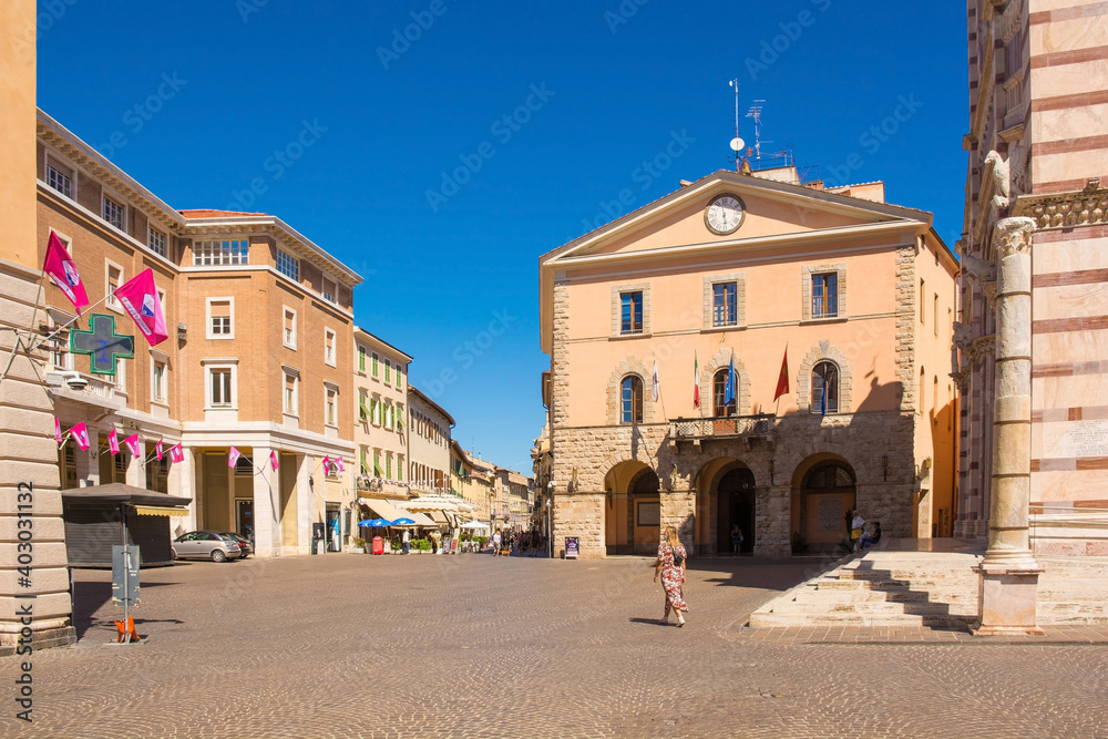 The historic Piazza Dante in central Grosseto in Tuscany, looking down Corso Giosue Carducci on the left. On the right is the Romanesque Cattedrale di San Lorenzo, Saint Lawrence Cathedral.
