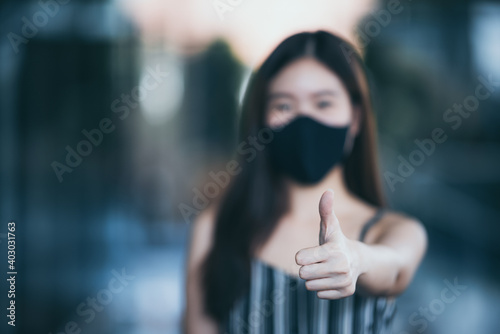 young Asian woman wearing surgical face mask for health protection, disease virus flu epidemic