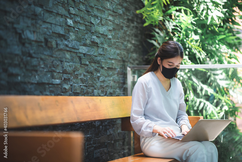 young Asian woman wearing surgical face mask for health protection, disease virus flu epidemic