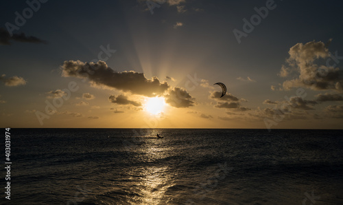 Kitesurfing person kitesurfer by sunset Bonaire Caribbean sea