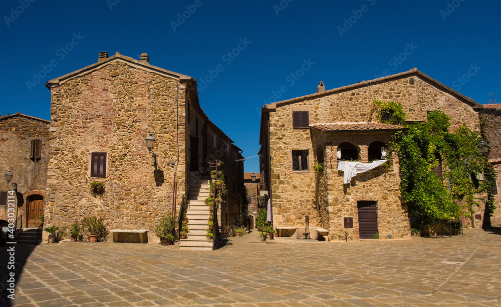 Historic stone residential buildings in the village of Montemerano near Manciano in Grosseto province, Tuscany, Italy
