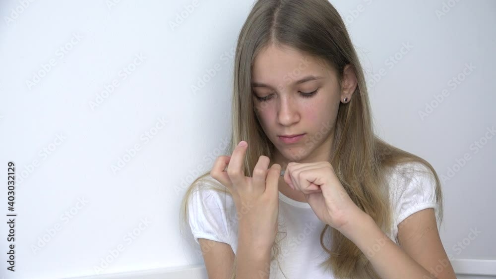 Adolescent Girl Polishing Fingernails doing Manicure, Teenager Child Cuts Nails Cuticle in Sofa, Kid Cutting Nails in Bedroom Adolescent Girl Polishing Fingernails doing Manicure, Teenager Child Cuts Nails Cuticle in Sofa, Kid Cutting Nails in Bedroom