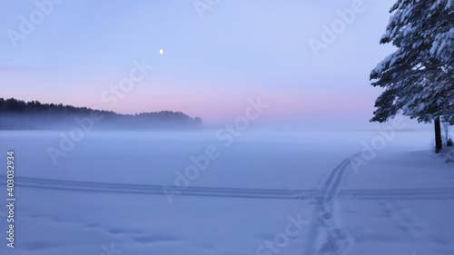 Russia  Karelia  Kostomuksha. The sun rises over the lake on a winter day.January 04  2021.