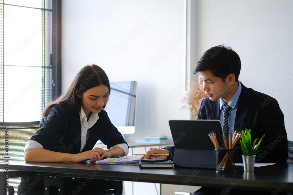Two business people working on their new project in modern office. Two business people working on their new project in modern office.