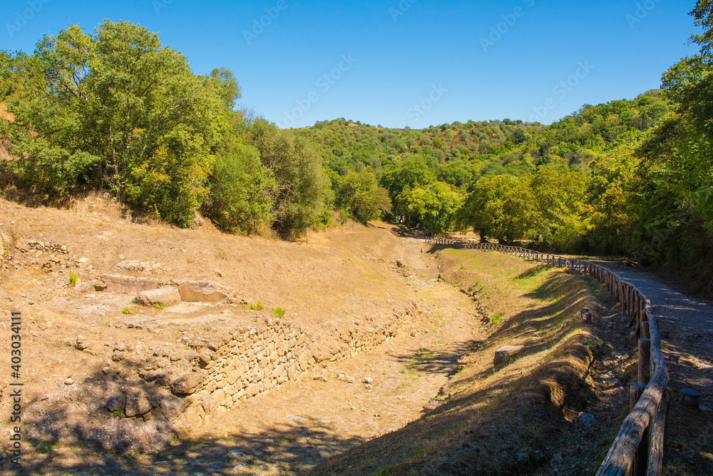 The ruins of  the Paved Etruscan Road in Roselle or Rusellae, an ancient Etruscan and Roman city in Tuscany. The road leads toward the centre of Roselle