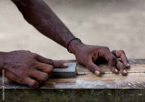 Man making a traditional shell necklaces, New Ireland Province, Kavieng, Papua New Guinea photo