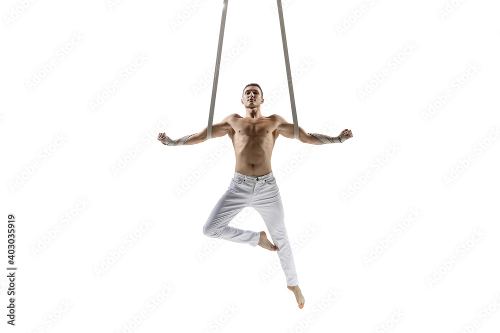 Warrior. Young male acrobat, circus athlete isolated on white studio background. Training perfect balanced in flight, rhythmic gymnastics artist practicing with equipment. Grace in performance. Warrior. Young male acrobat, circus athlete isolated on white studio background. Training perfect balanced in flight, rhythmic gymnastics artist practicing with equipment. Grace in performance.