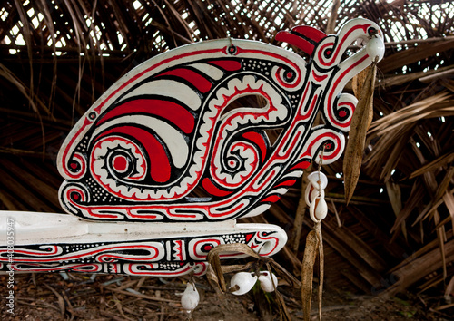 Traditional canoe with carved and painted decorations, Milne Bay Province, Alotau, Papua New Guinea photo