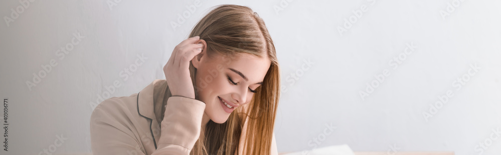 awake and positive woman in satin pajamas adjusting hair, banner awake and positive woman in satin pajamas adjusting hair, banner