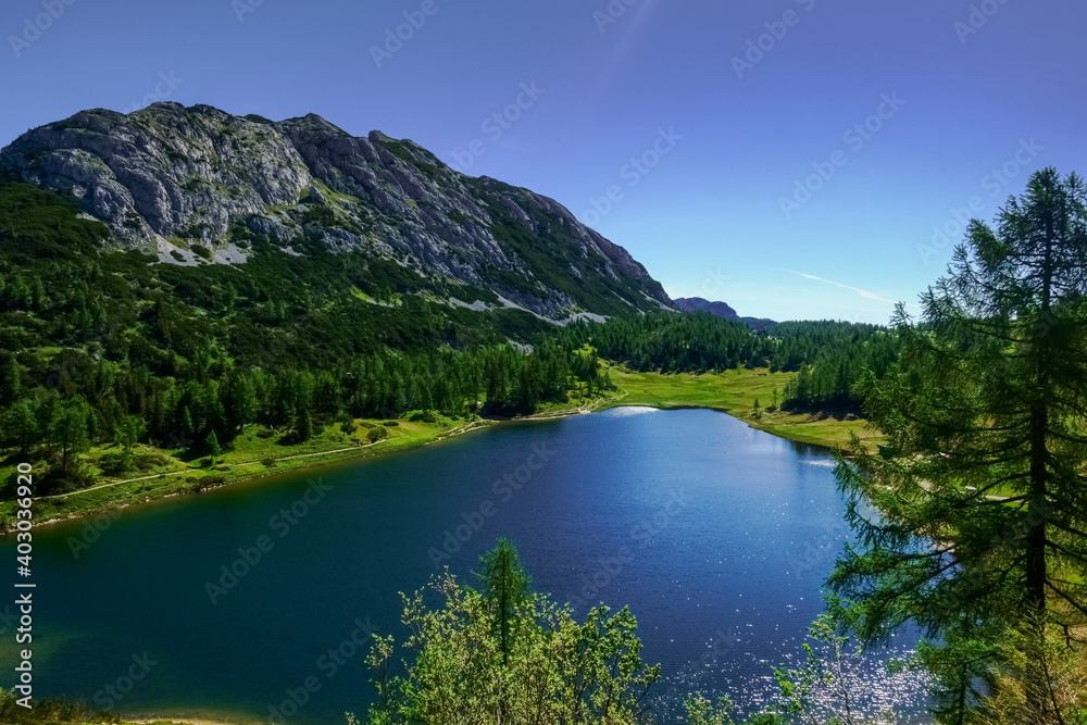 glittering water from a mountain lake with trails in the summer glittering water from a mountain lake with trails in the summer