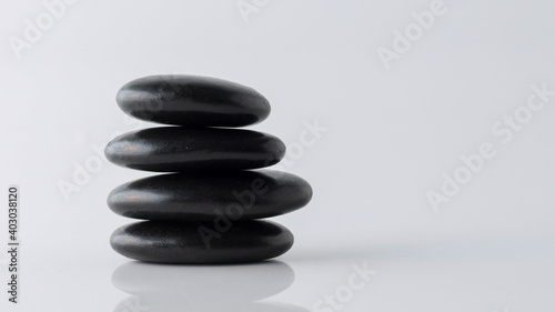  stacked black stones on white background