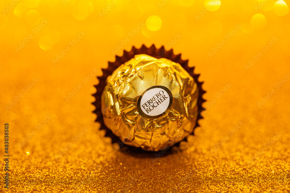 isolated Ferrero Rocher premium chocolate on golden glitter