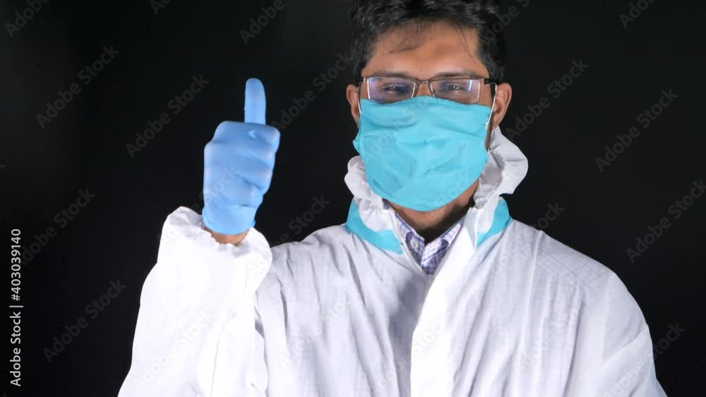 male doctor's hand in medical gloves showing a thumb-up. male doctor's hand in medical gloves showing a thumb-up.