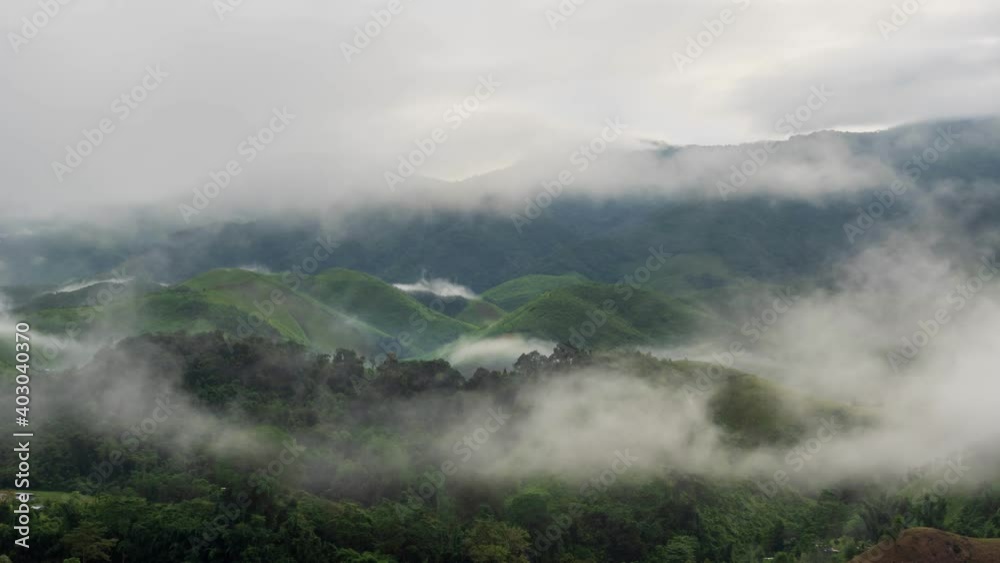 Timelapse of valley surrounded by mountains and covered with dense ground fog and mist High peaks wonderful morning sunrise natural Landscape. Sapan village, nan province Thailand. Timelapse of valley surrounded by mountains and covered with dense ground fog and mist High peaks wonderful morning sunrise natural Landscape. Sapan village, nan province Thailand.