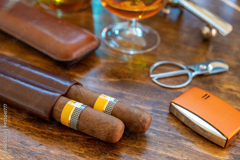 Cuban cigars and smoking accessories on wooden desk