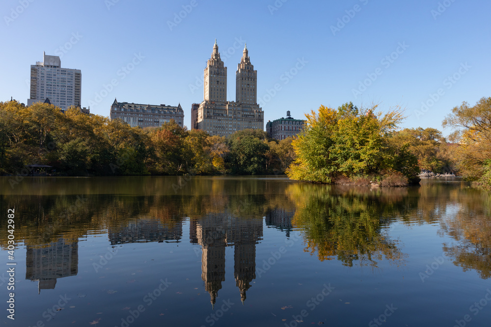 The Lake at Central Park during Autumn with the Upper West Side Skyline Reflection and Colorful Trees in New York City The Lake at Central Park during Autumn with the Upper West Side Skyline Reflection and Colorful Trees in New York City