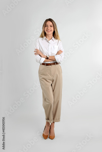 Full length portrait of beautiful young businesswoman on white background