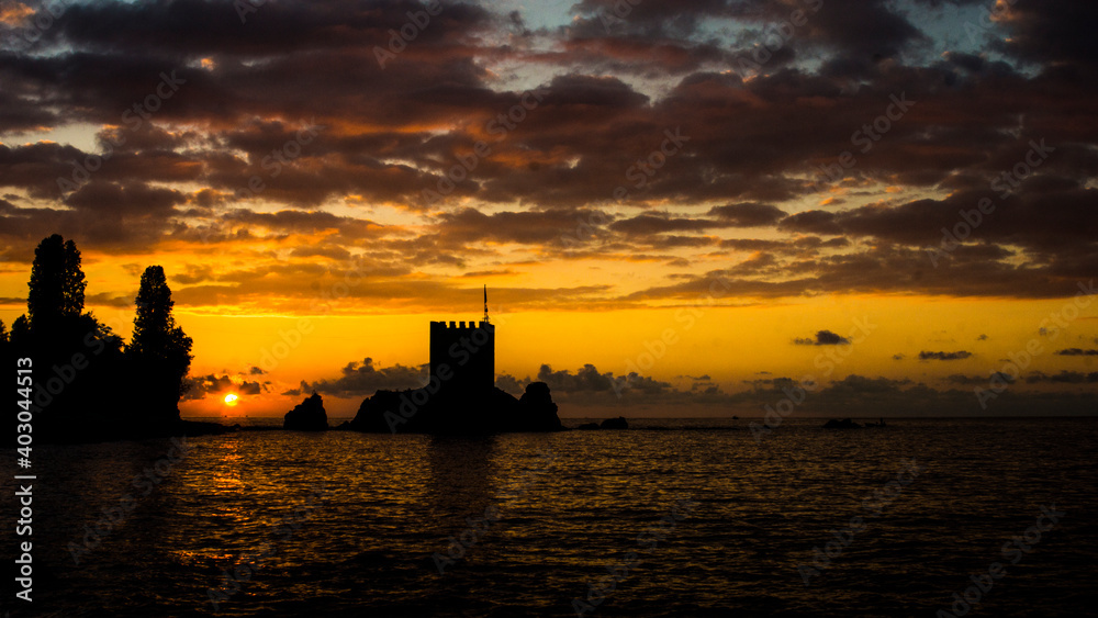 Image of a castle by the sea taken at sunset. Relaxing landscape formed by the reflection of the rays reflected from the sun into the sea