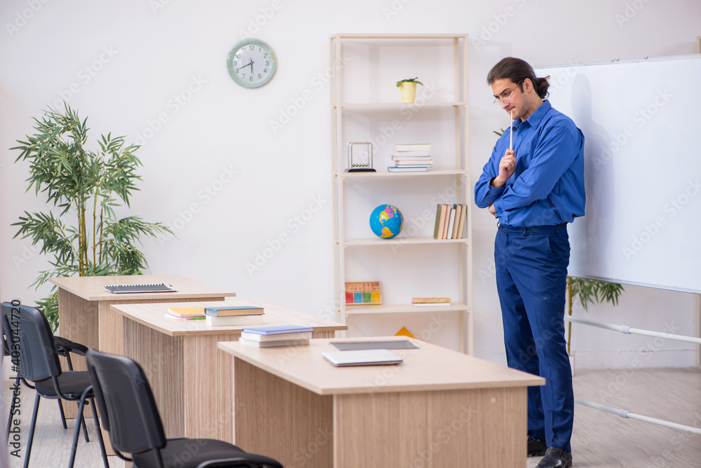Young male teacher in front of white board Young male teacher in front of white board