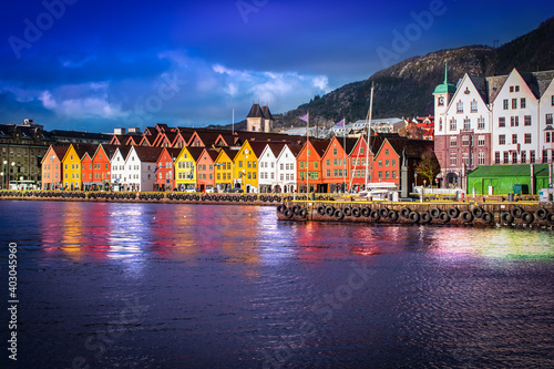 Bryggen in Bergen at night. Traditional colorful wooden houses on the quayside of the historic harbor district. Famous landmark in Norway.