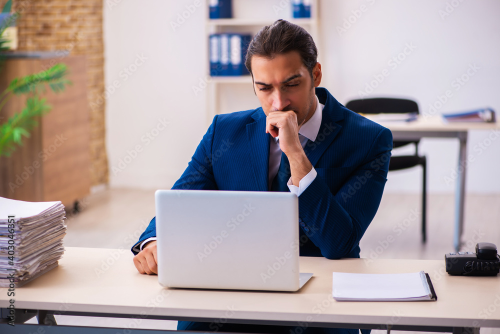 Young male employee working in the office Young male employee working in the office