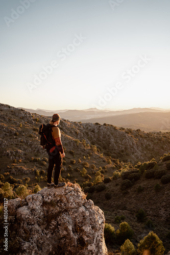 Man mountains at sunset, concept of adventure and trekking