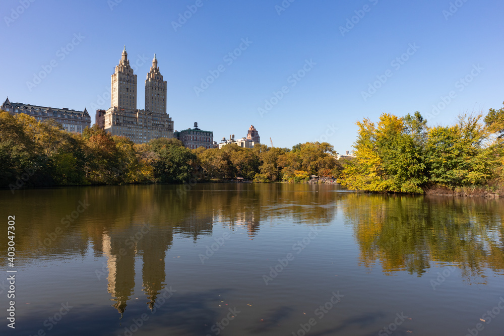 The Lake at Central Park during Autumn with the Upper West Side Skyline Reflection and Colorful Trees in New York City
