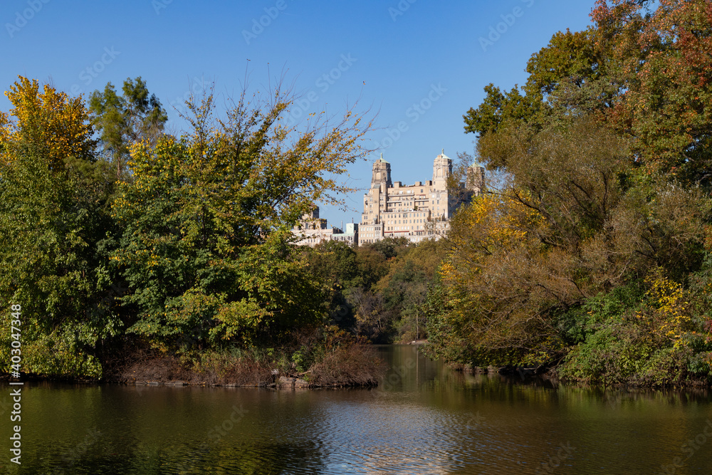 The Lake at Central Park during Autumn with the Upper West Side Skyline and Colorful Trees in New York City The Lake at Central Park during Autumn with the Upper West Side Skyline and Colorful Trees in New York City