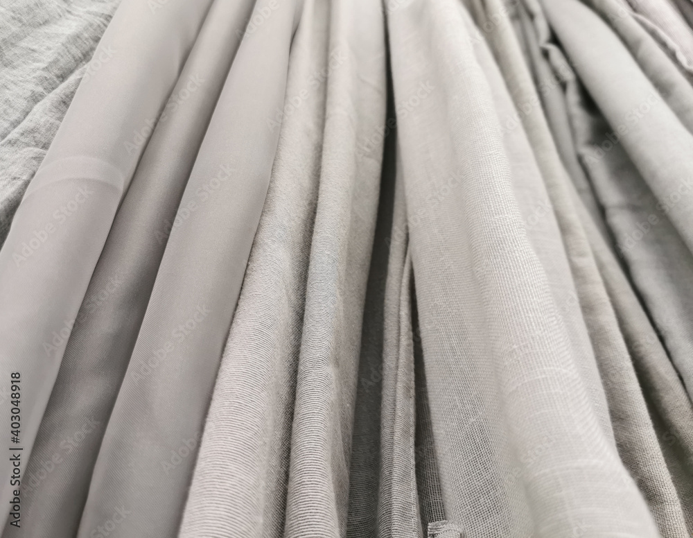 Obraz premium Detailed close up view on samples of cloth and fabrics in different colors found at a fabrics market. selective focus,