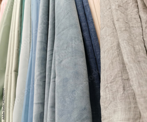 Detailed close up view on samples of cloth and fabrics in different colors found at a fabrics market. selective focus,