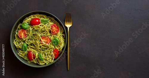 Pasta spaghetti with pesto sauce, tomatoes and basil. Healthy eating. Vegetarian food.