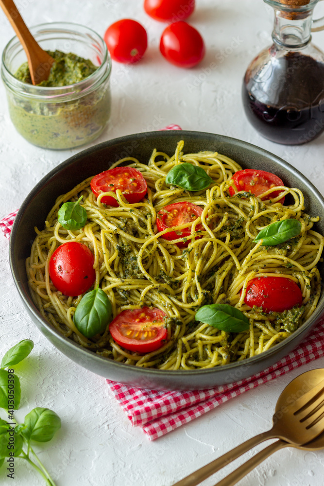 Pasta spaghetti with pesto sauce, tomatoes and basil. Healthy eating. Vegetarian food.