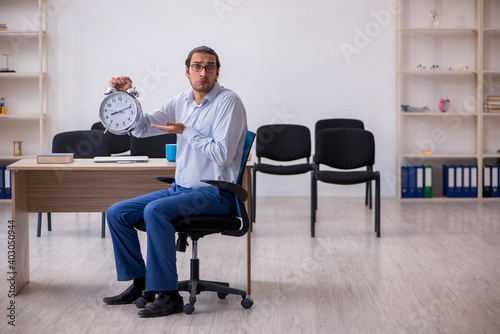 Young male boss giving seminar in the office during pandemic