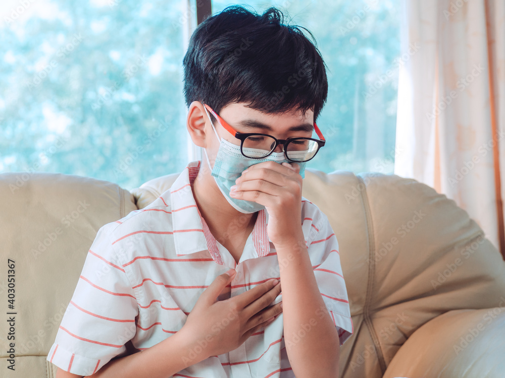 Little ill boy get sore throat and and cough with unhappy and wearing