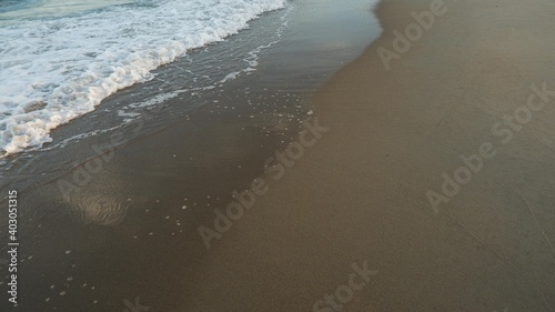 Clear sea water, wave and sand beach. Text space.